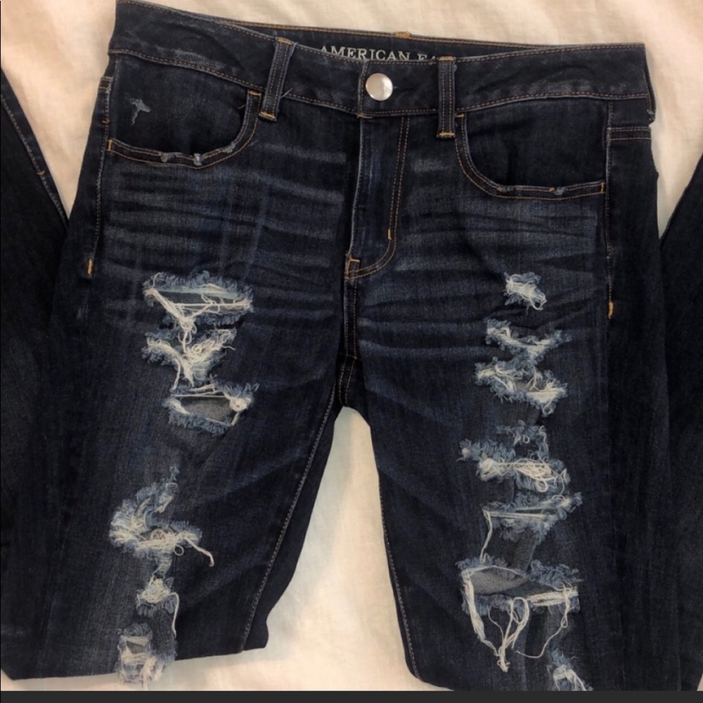 A pair of distressed American eagle jeggings